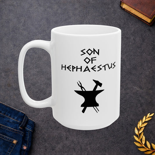 A minimalist black graphic for a white ceramic mug. The design features a central silhouette of a blacksmith's anvil with a hammer and tongs crossed behind it. Above the tools, the text "SON OF HEPHAESTUS" is written in a sharp, angular font inspired by ancient Greek inscriptions. The entire illustration is rendered in a clean, solid black style.