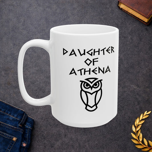 White ceramic mug graphic featuring bold ancient Greek-style lettering reading "Daughter of Athena" above a clean geometric line-art owl icon — referencing Athena, the Greek Goddess of Wisdom, whose sacred symbol is the owl, rendered in white on black in a striking high-contrast design.