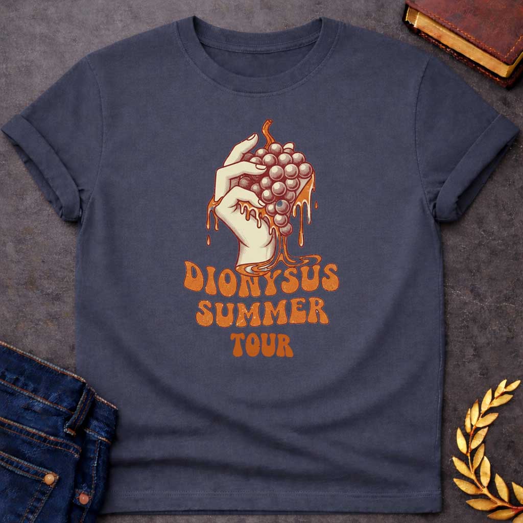 Dark Heather T-shirt graphic featuring a vintage-style illustration of a hand squeezing a bunch of grapes with juice dripping down, rendered in a retro halftone print style in cream and burnt orange tones. Bold groovy retro lettering below reads "Dionysus Summer Tour," inspired by 1970s rock concert merchandise design