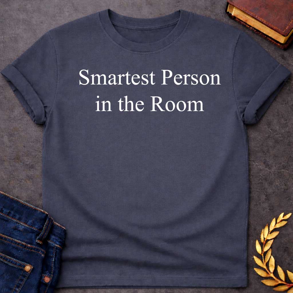 Dark Heather T-shirt graphic in white featuring large elegant serif text reading "Smartest Person in the Room" — a confident nod to Athena, the Greek Goddess of Wisdom