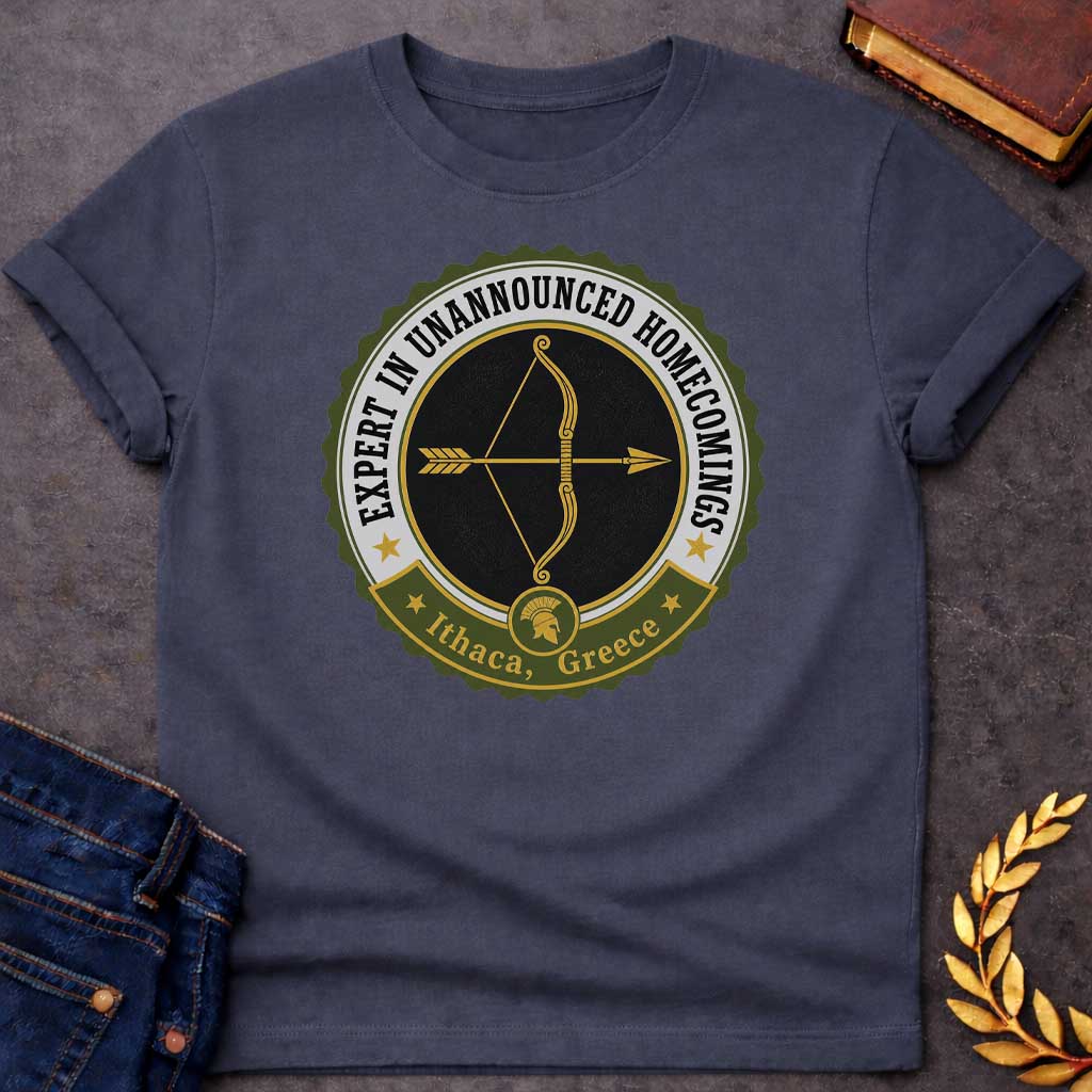 Dark Heather T-shirt with a graphic featuring a vintage military challenge coin-style badge design in olive green, black, gold, and white. A golden bow and arrow are centered on a black background within the circular badge, with text arched around the outer ring reading "Expert in Unannounced Homecomings" flanked by gold stars. A green ribbon banner at the bottom features a Spartan helmet medallion and reads "Ithaca, Greece" with gold stars — a humorous reference to Odysseus, the hero of Homer's Odyssey who