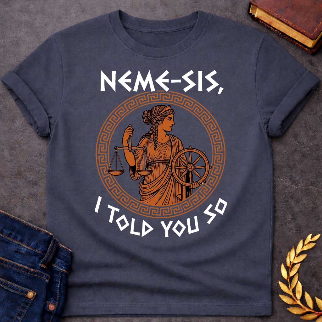 Dark Heather T-shirt with an Ancient Greek pottery-style illustration of Nemesis, the goddess of divine retribution, rendered in terracotta and black. She wears flowing robes and holds balanced scales of justice in one hand and a ship's wheel in the other, symbolizing fate and accountability. Her braided hair is styled in classical Greek fashion. Enclosed in a Greek key pattern circular border. Bold text reads 'NEMESIS, I TOLD YOU SO' above and below. References the goddess who ensures justice.