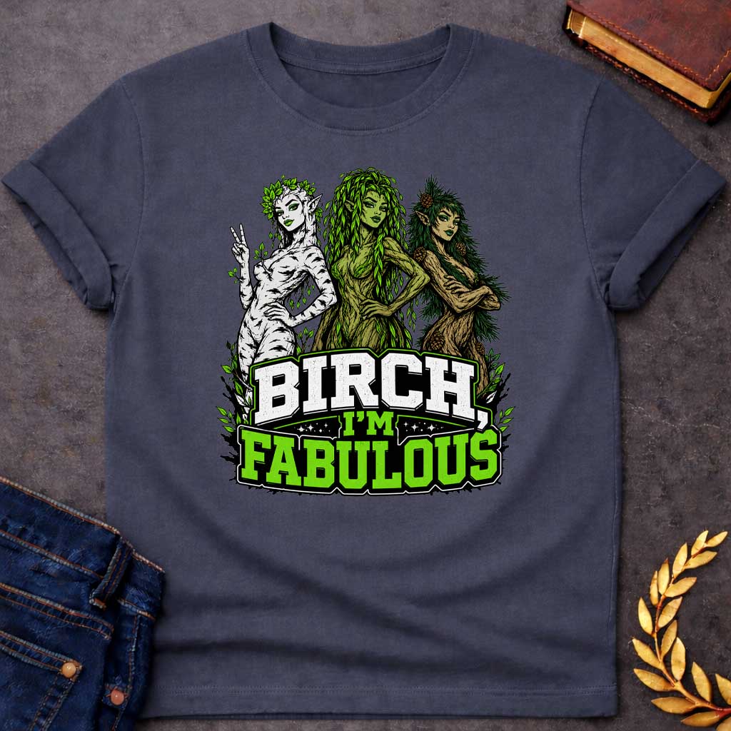 Dark Heather T-shirt with a pun-based Greek mythology t-shirt design featuring a detailed engraving-style portrait of a hamadryad emerging from a birch trunk. She has long flowing hair, wears a floral wreath, and looks aside with a dramatic, sassy expression. Arched above her head is the bold black text "BIRCH, I'M FABULOUS" in a clean serif font. The entire graphic uses an elegant, fine-line black and white aesthetic