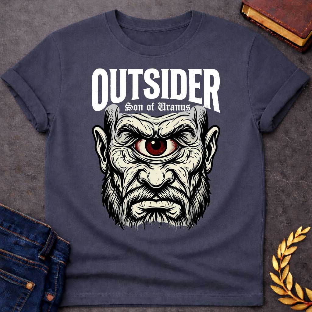 Dark Heather T-shirt with a Bold typography design featuring a single-eyed Titan face with fierce expression. Thick white beard and long flowing hair frame a menacing red eye with intense gaze. Black and white engraving style with intricate line work emphasizing the character's otherworldly nature. Text reads 'OUTSIDER' and 'Son of Uranus' referencing the Titans of Greek mythology. Celebrates mythological outsider status, divine rebellion, and powerful, untamed forces beyond mortal comprehension.