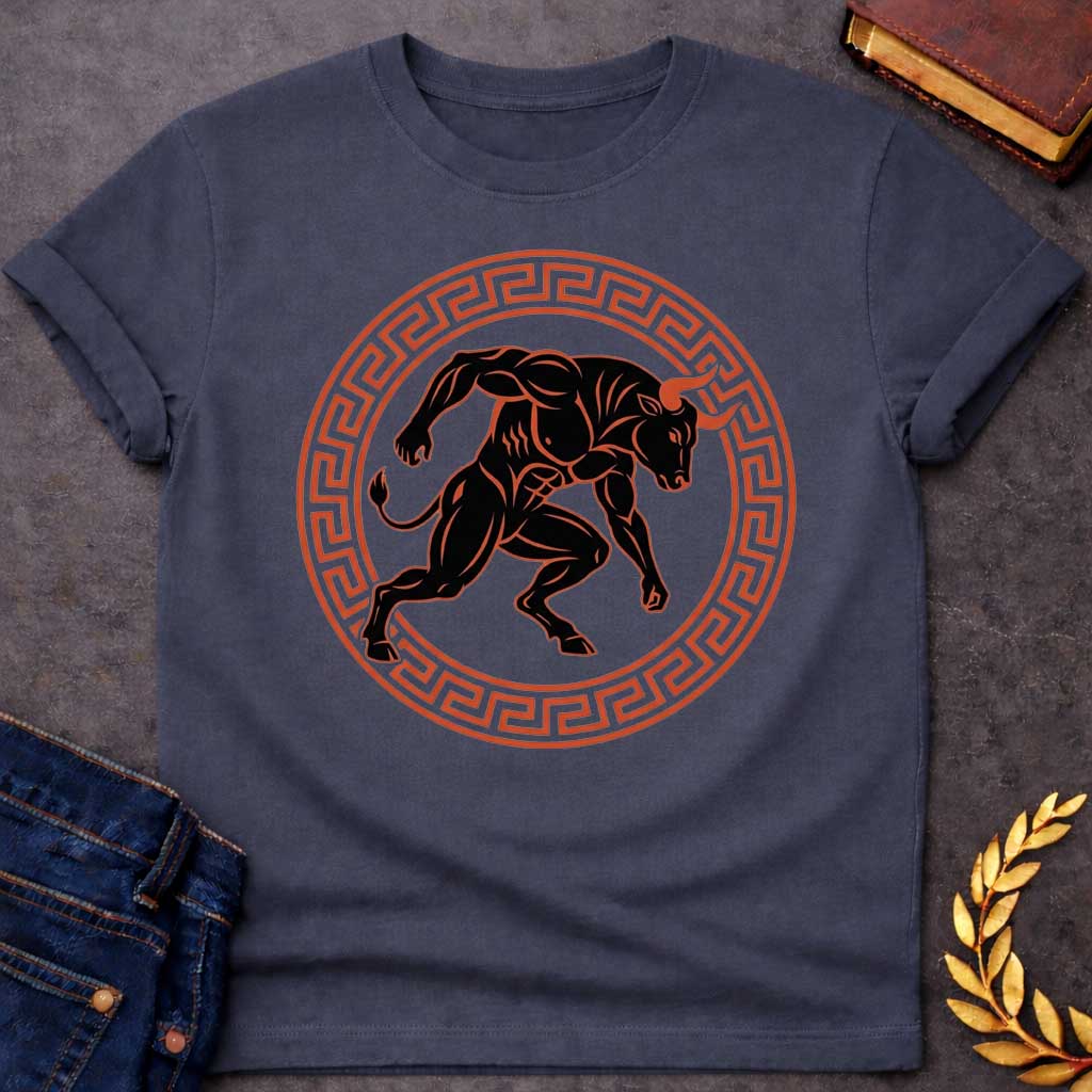 Dark Heather T-shirt with A minimalist, athletic-style t-shirt graphic. At the center is a highly muscular, black silhouette of a charging Minotaur with orange-red highlights and sharp horns. The dynamic creature is enclosed within a circular frame decorated with a classic terracotta-colored ancient Greek key (meander) pattern, creating a bold, timeless emblem design for apparel.