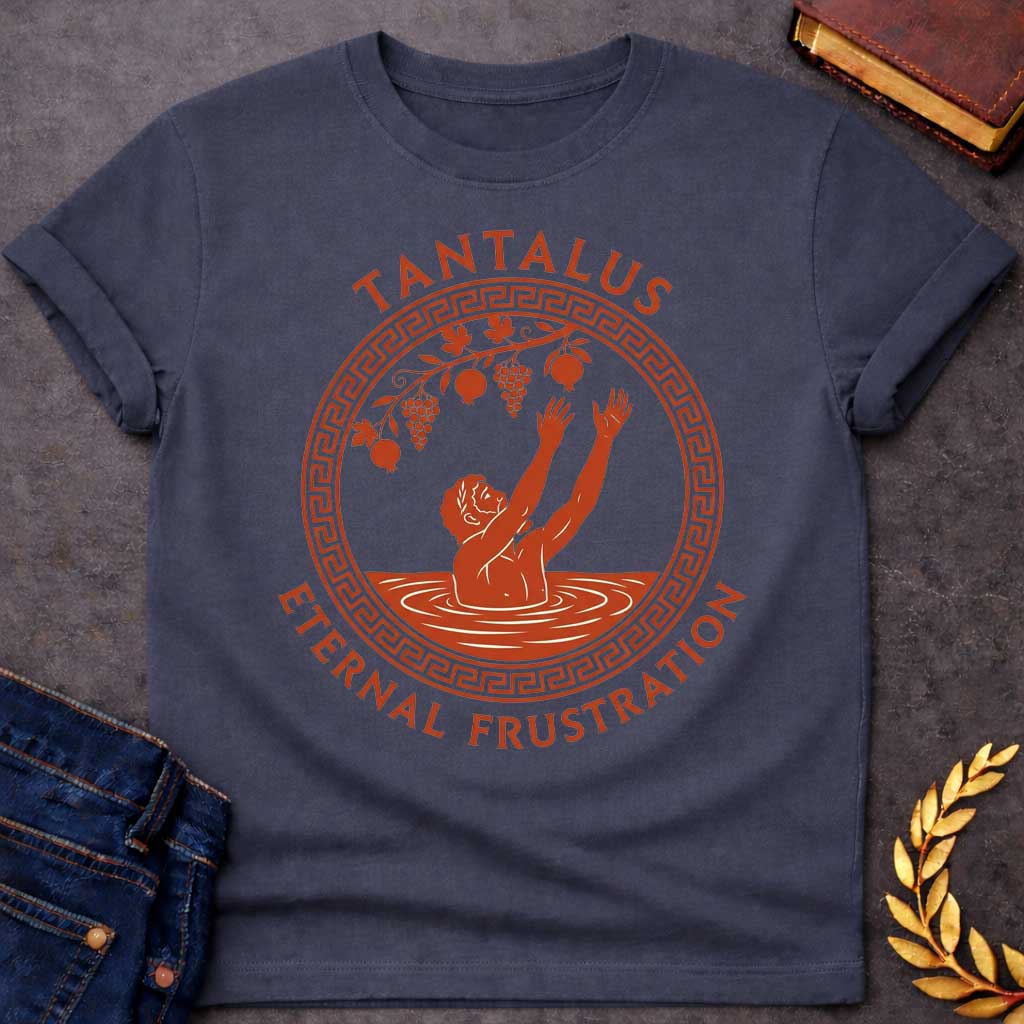 Dark Heather t-shirt with An ancient Greek pottery-style t-shirt graphic for "enternal frustration.jpg". Inside a circular terracotta frame with a classic meander key pattern, a figure stands waist-deep in water reaching both hands up toward dangling grapes and pomegranates. Arched above the emblem, bold terracotta text reads "TANTALUS", while the phrase "ETERNAL FRUSTRATION" curves around the bottom in matching serif typography.