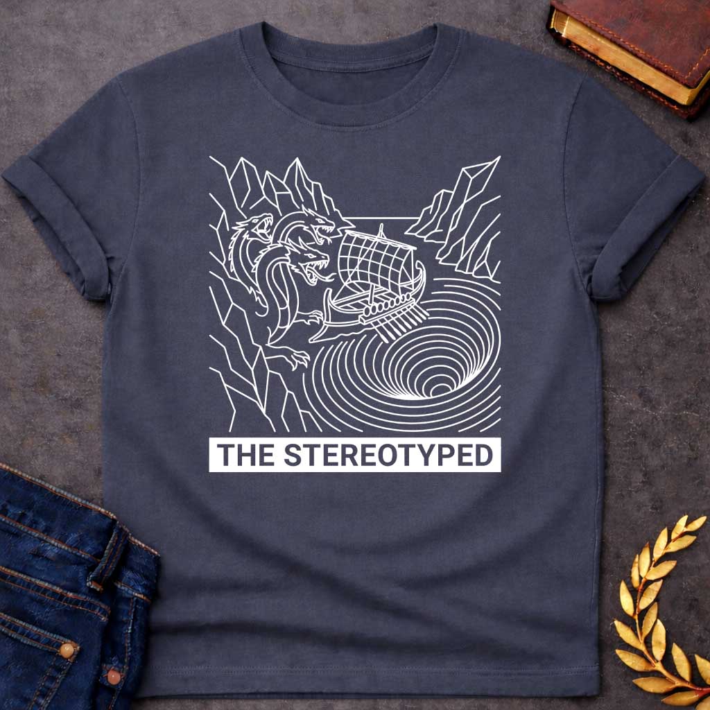 Dark Heather t-shirt with A clean, line art t-shirt design. Rendered in white line work, an ancient Greek galley ship navigates between a three-headed sea monster on jagged cliffs and a concentric, swirling whirlpool. Below the graphic, a solid dark blue rectangular banner features white, sans-serif block text that reads "THE STEREOTYPED".
