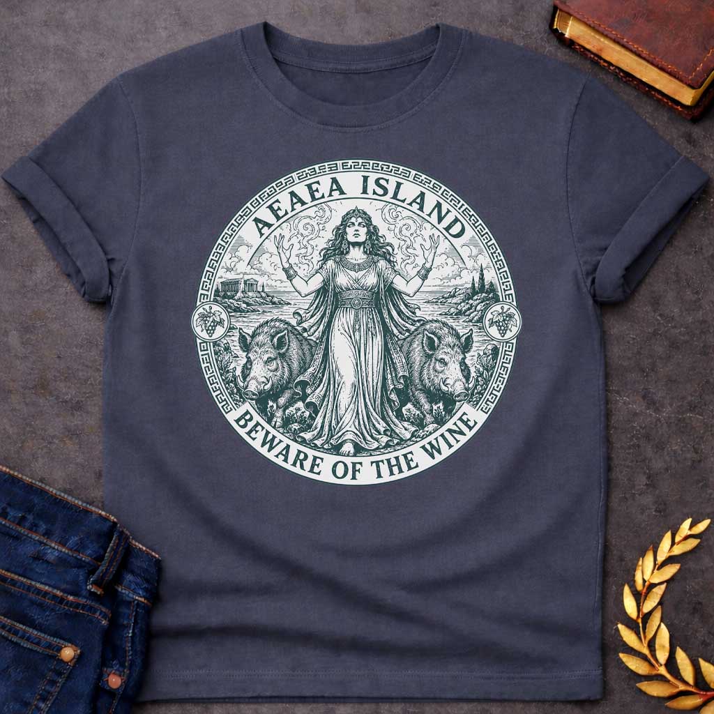 Dark Heather T-shirt with a Classical engraving-style illustration of Circe, the Greek goddess of magic, commanding her island of Aeaea with raised arms and mystical power. She wears an ornate crown and flowing draped robes adorned with jewelry. Two human-headed pigs flank her, representing men transformed through her enchanted wine. Grape vines with fruit surround the mystical coastal scene. Greek key pattern border in teal frames the circular composition. Text reads 'Aeaea Island' and 'Beware of the Wine.