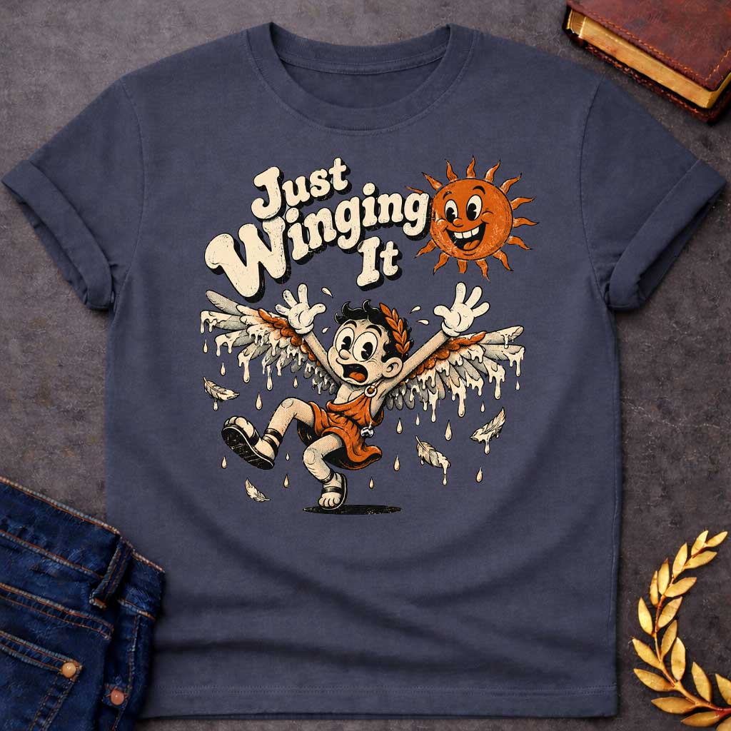 Dark Heather t-shirt with a vintage 1930s rubber-hose cartoon style design. A panicked boy representing Icarus tumbles through the air with arms raised as his feathered wax wings melt into dripping drops. Above him, a cheerful retro sun character grins mischievously next to playful, bubbly text that reads "Just Winging It" in a distressed cream font.