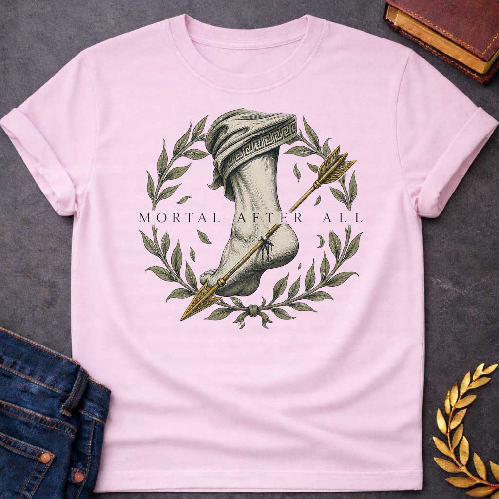 Light Pink T-Shirt with a classical engraving-style illustration depicting Achilles' fatal vulnerability. A muscular leg and foot rendered in detailed cross-hatching, draped in cloth with Greek key pattern. A golden arrow pierces the heel. Framed by a laurel wreath with olive-green leaves and falling leaves, symbolizing victory and mortality. Elegant serif text reads 'MORTAL AFTER ALL.' Muted tones of cream, grey, olive green, and gold create a somber quality reflecting Achilles' death by arrow to his only
