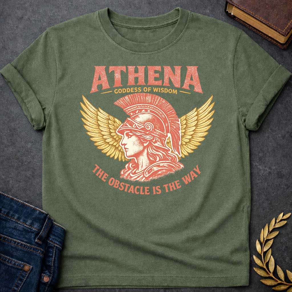 Military Green t-shirt graphic featuring a side-profile illustration of Athena wearing a Corinthian helmet with a red plume, flanked by large golden wings. Text reads "ATHENA – Goddess of Wisdom" arched above and "The Obstacle Is the Way" curved below, in a vintage Greek mythology style with rose and gold tones