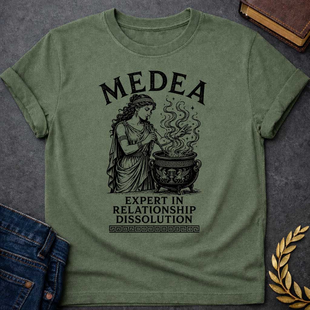 Military Green T-shirt with a Classical engraving of Medea, the legendary Greek sorceress, in flowing draped robes with Greek key pattern headband. She stirs a decorative cauldron with magical swirling smoke and stars rising dramatically from within. Black and white line art style with intricate detailing. Text reads 'Medea' above and 'Expert in Relationship Dissolution' below with Greek key border. Dark humor celebrates Medea's infamous reputation for magical vengeance and relationship destruction.