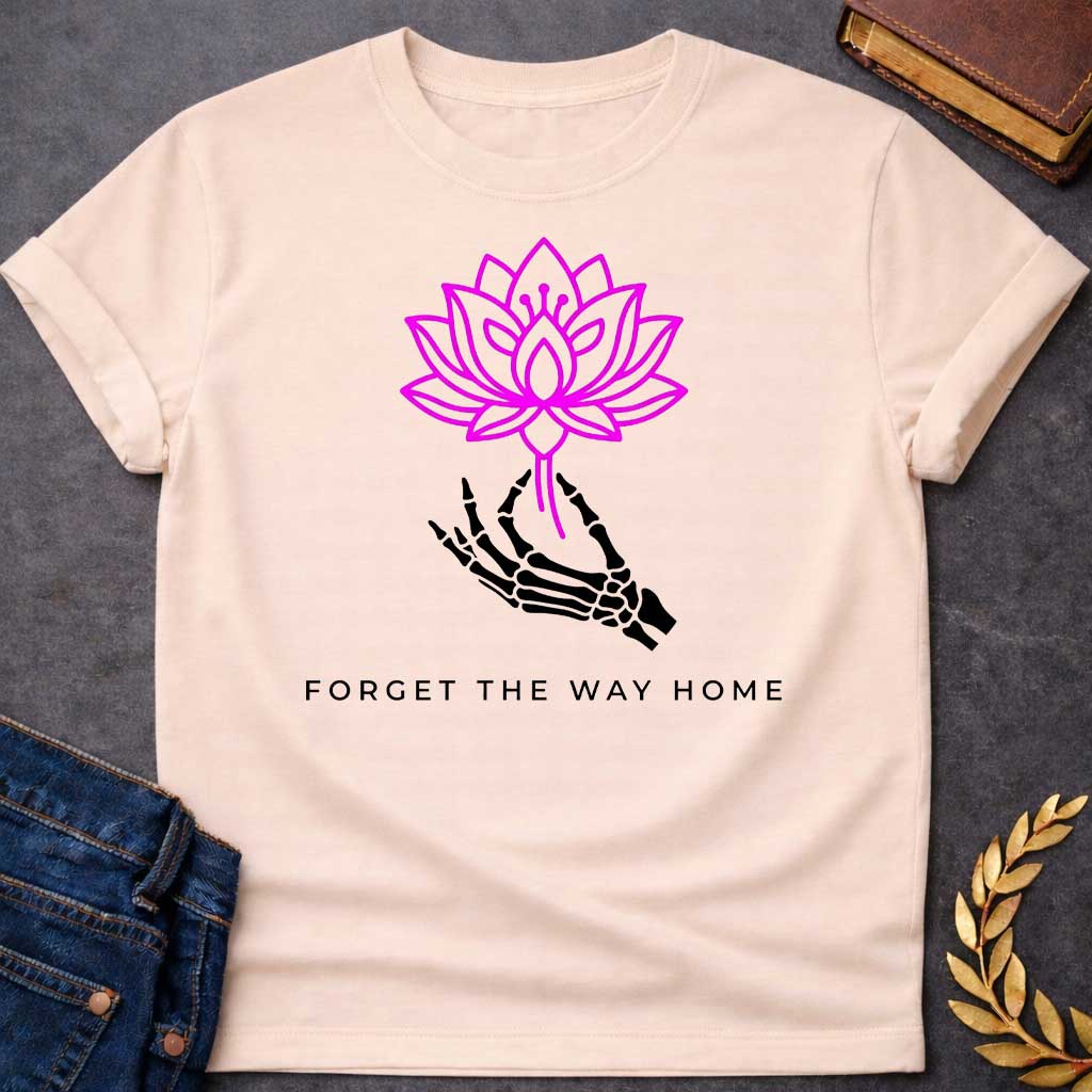 Natural T-shirt with a graphic featuring a bold magenta line-art lotus flower held delicately by a black skeletal hand, with spaced bold sans-serif text below reading "Forget the Way Home" — a darkly humorous reference to the Land of the Lotus-Eaters episode in Homer's Odyssey, where Odysseus's crew ate lotus flowers and forgot their desire to return home
