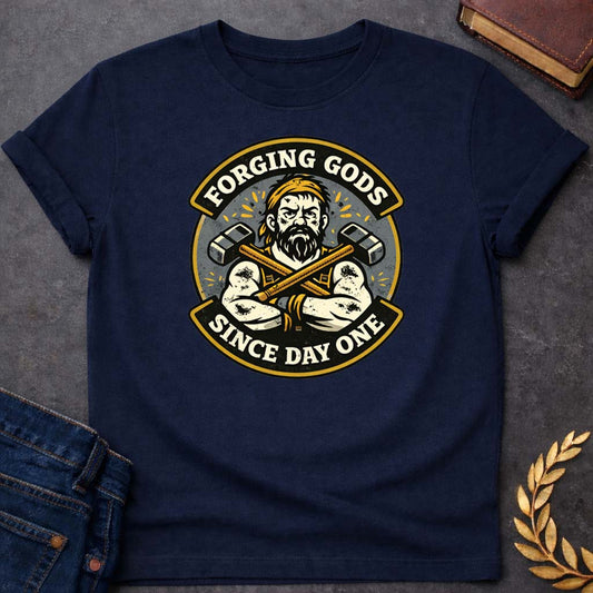 Hephaestus Forging Gods Since Day One Greek Mythology Adult T-Shirt featuring blacksmith hammer, forge sparks, fire god symbolism in industrial mythology design