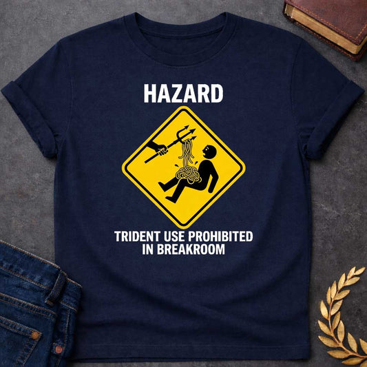 Navy T-Shirt with a humorous design featuring a bold, yellow, diamond-shaped warning sign. Inside the sign, a stick figure falls backward, looking shocked as a pile of tangled yellow spaghetti spills from their chest and stomach. Above them, an outstretched black silhouette of a hand holds a trident, which has a forkful of the spaghetti tangled in its tines, appearing to have just pulled the pasta away. Above the sign, the word "HAZARD" is printed in large, white, block letters. Below the sign, the text "TR