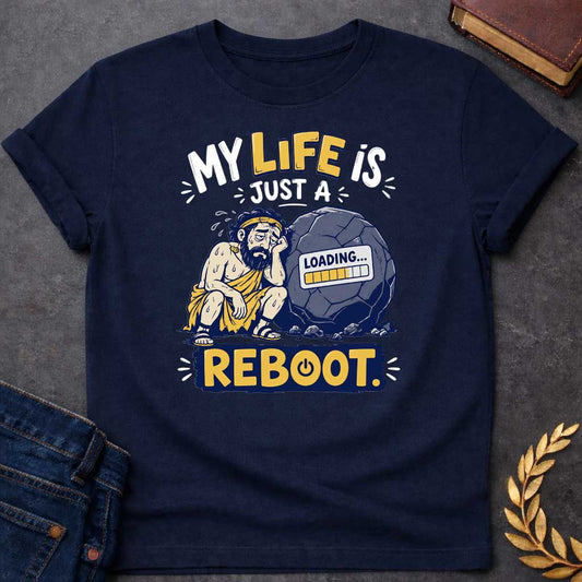 Navy T-Shirt with a humorous graphic design featuring a stylized, weary-looking Sisyphus sitting next to his iconic boulder. The boulder features a digital "LOADING..." progress bar on its surface. The text above reads "MY LIFE IS JUST A" and the word "REBOOT." is featured prominently at the bottom in a bold, yellow block with a power symbol integrated into the letter 'O'. The design uses a color palette of muted blues, yellows, and grays, set against a white background.