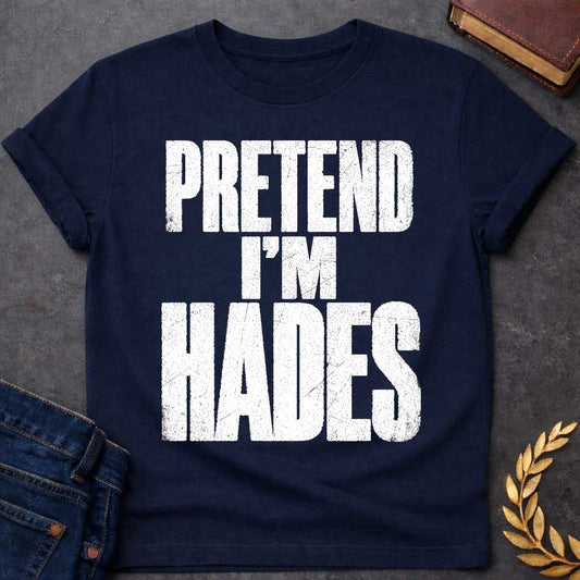 Navy t-shirt with a Pretend I’m Hades Greek mythology design featuring bold distressed white typography on a transparent background. The stacked text reads “PRETEND I’M HADES” in a rugged vintage block font, creating a humorous design inspired by Hades, the Greek god of the underworld, the dead, and riches.