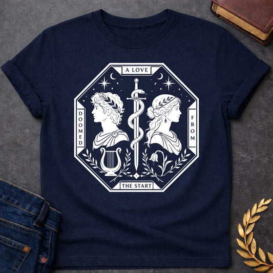Navy t-shirt in white tarot-card style: an octagonal frame shows two facing silhouette profiles (a laurel-crowned man and a woman with a headband) separated by a snake-entwined sword. Below them sit a lyre and a drooping flower, framed by olive branches, stars, and crescent moons, evoking Orpheus and Eurydice.