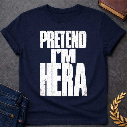 Navy t-shirt with a Pretend I’m Hera Greek mythology design featuring bold distressed white typography on a transparent background. The stacked text reads “PRETEND I’M HERA” in a rugged vintage block font, creating a humorous design inspired by Hera, the Greek goddess of marriage, women, family, and queen of the Olympian gods.