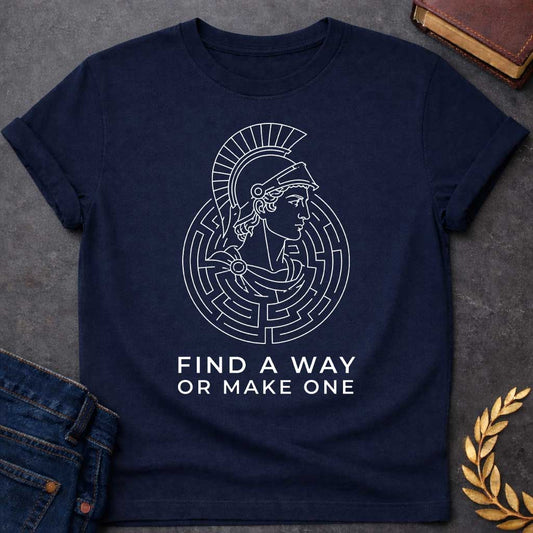 Navy T-shirt with A Classical profile of a Spartan warrior wearing a crested Corinthian helmet, surrounded by concentric circular maze patterns forming an intricate labyrinth. Black and white line art style. Text reads 'Find A Way Or Make One' below. Motivational design celebrating determination, problem-solving, and perseverance. References Theseus's escape from the mythological Cretian labyrinth while embodying warrior resilience and grit.