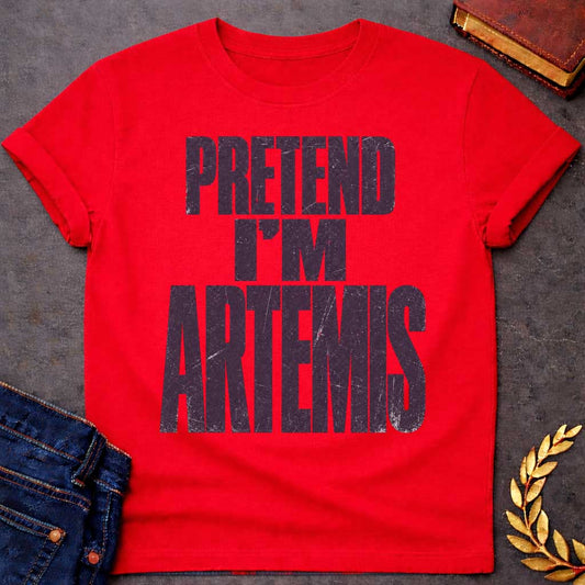 Red t-shirt with a Pretend I’m Artemis Greek mythology design featuring bold distressed purple typography on a transparent background. The stacked text reads “PRETEND I’M ARTEMIS” in a rugged vintage block font, creating a humorous design inspired by Artemis, the Greek goddess of the hunt, wilderness, wild animals, archery, and the moon.