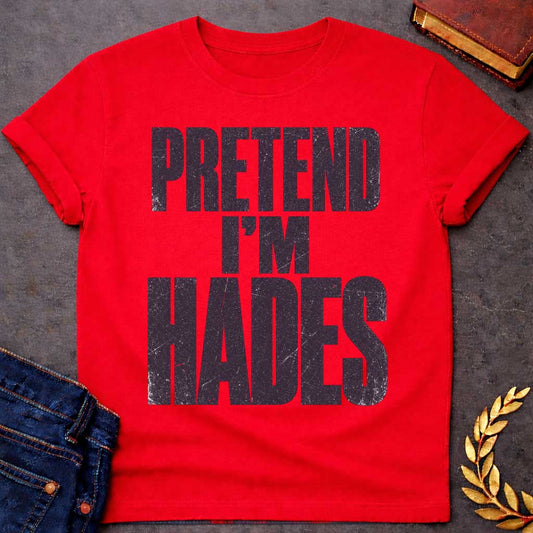 Red t-shirt with a Pretend I’m Hades Greek mythology design featuring bold distressed dark purple typography on a transparent background. The stacked text reads “PRETEND I’M HADES” in a rugged vintage block font, creating a humorous design inspired by Hades, the Greek god of the underworld, the dead, and riches.