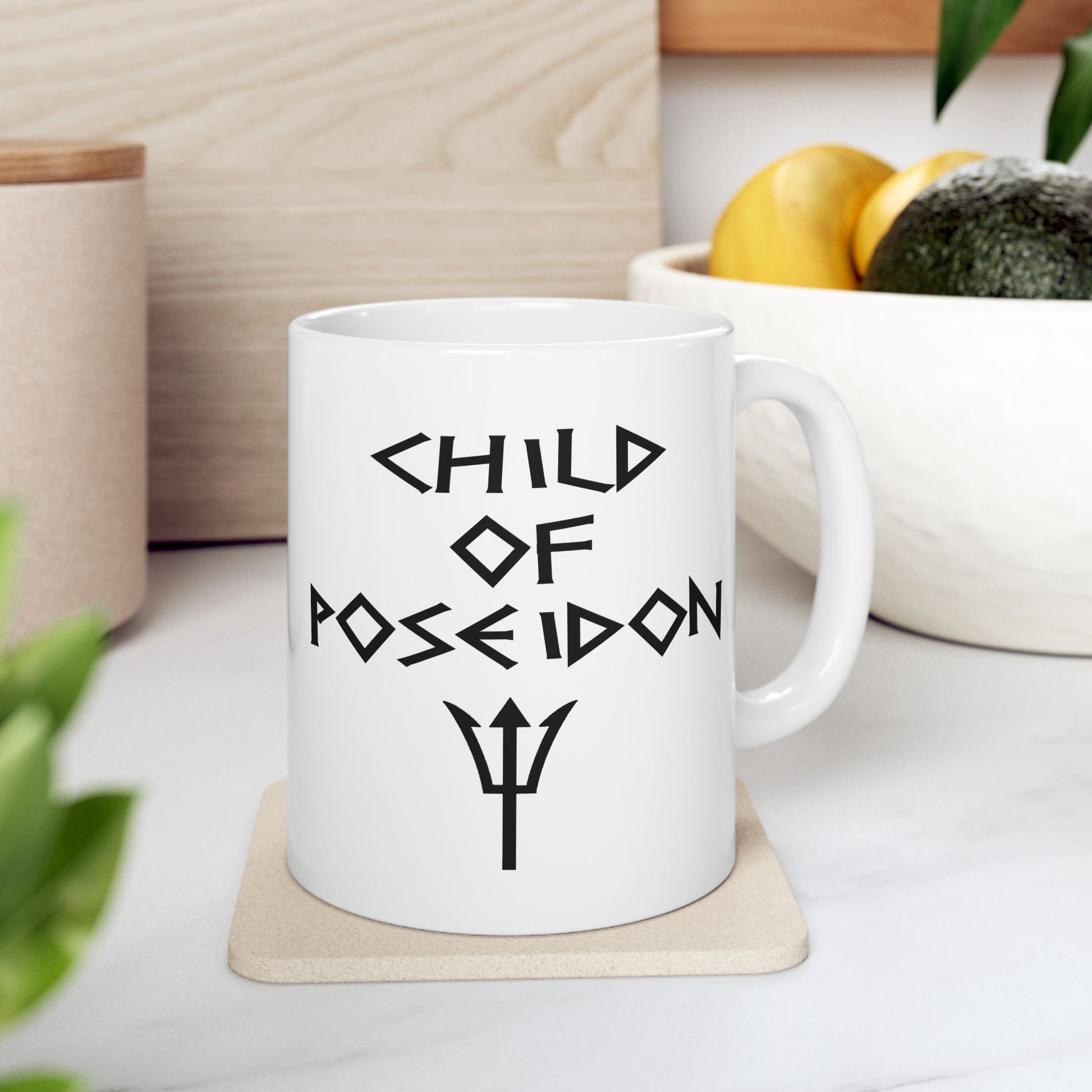 A minimalist black graphic for a white ceramic mug featuring a central silhouette of a trident. Above the trident, the text "SON OF POSEIDON" is written in a sharp, angular font reminiscent of ancient Greek epigraphy. The entire design is rendered in a clean, high-contrast black style.