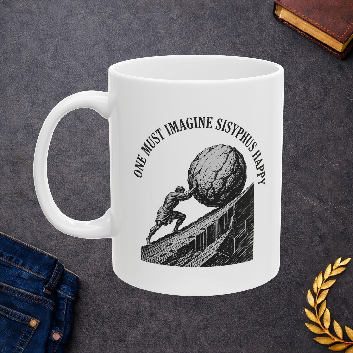 Philosophical engraving-style illustration on a ceramic mug depicting Sisyphus pushing a massive boulder up an inclined slope. Black and white line work shows the muscular figure in eternal struggle against gravity. Text curves around the image reading 'One Must Imagine Sisyphus Happy,' referencing Albert Camus's essay on absurdism. Celebrates the philosophical concept of finding meaning and happiness within repetitive, seemingly futile tasks. Profound meditation on human resilience and existential meaning.