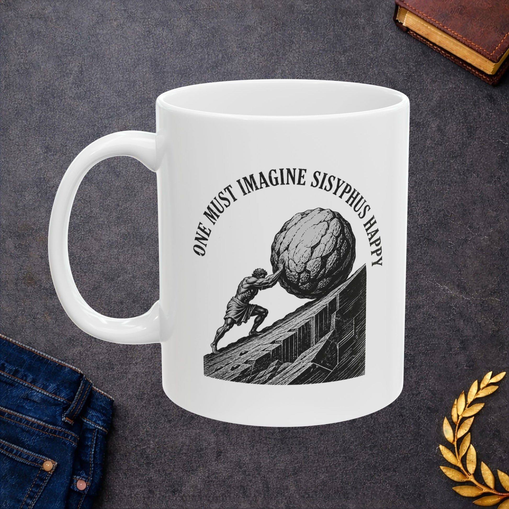 Philosophical engraving-style illustration on a ceramic mug depicting Sisyphus pushing a massive boulder up an inclined slope. Black and white line work shows the muscular figure in eternal struggle against gravity. Text curves around the image reading 'One Must Imagine Sisyphus Happy,' referencing Albert Camus's essay on absurdism. Celebrates the philosophical concept of finding meaning and happiness within repetitive, seemingly futile tasks. Profound meditation on human resilience and existential meaning.