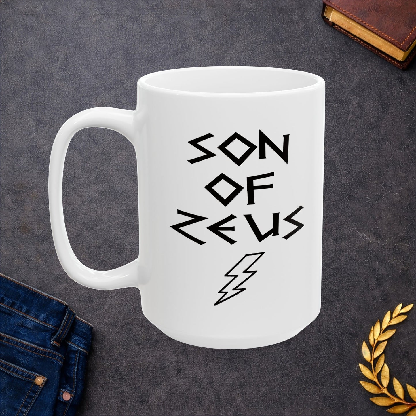 A minimalist black graphic for a white ceramic mug featuring a large, central outline of a lightning bolt. Above the bolt, the text "SON OF ZEUS" is written in a sharp, angular font inspired by ancient Greek inscriptions. The entire design is rendered in a clean, high-contrast black outline style.