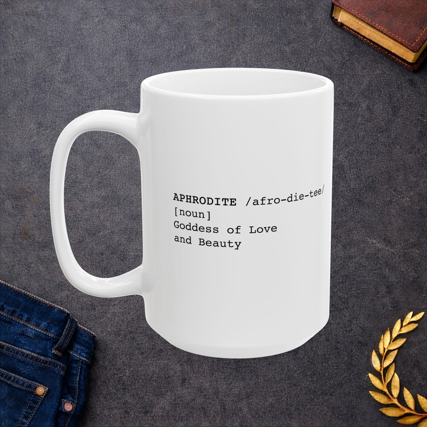 White ceramic mug featuring a dictionary-style definition graphic in black text on a white background. The text reads: 'APHRODITE /afro-die-tee/ [noun] Goddess of Love and Beauty.