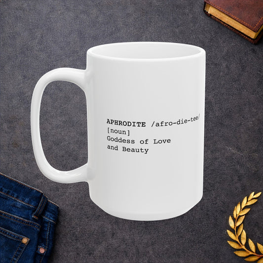 White ceramic mug featuring a dictionary-style definition graphic in black text on a white background. The text reads: 'APHRODITE /afro-die-tee/ [noun] Goddess of Love and Beauty.