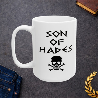 A bold, dark-themed graphic for a white ceramic mug. The design features a large, detailed outline of a skull and crossbones at the center. Above the skull, the words "SON OF HADES" are written in a sharp, ancient Greek-inspired angular font. The entire design is rendered in a clean, high-contrast black outline style.