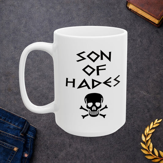 A bold, dark-themed graphic for a white ceramic mug. The design features a large, detailed outline of a skull and crossbones at the center. Above the skull, the words "SON OF HADES" are written in a sharp, ancient Greek-inspired angular font. The entire design is rendered in a clean, high-contrast black outline style.