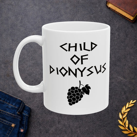 White ceramic mug featuring a minimalist, Greek-inspired graphic in black ink on a white background. The design reads 'CHILD OF DIONYSUS' in a stylized, angular font, positioned above a clean, line-art graphic of a cluster of grapes hanging from a vine with leaves.