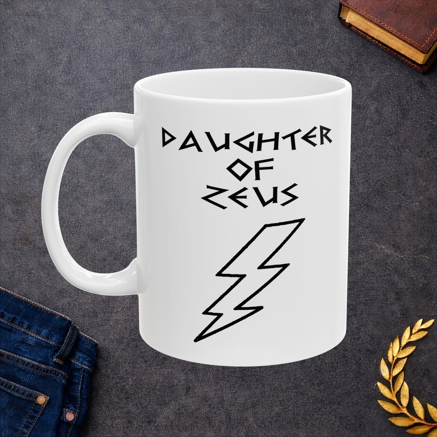 A minimalist black graphic for a white ceramic mug featuring a large, central outline of a lightning bolt. Above the bolt, the text "DAUGHTER OF ZEUS" is written in a sharp, angular font inspired by ancient Greek inscriptions. The entire design is rendered in a clean, high-contrast black outline style.