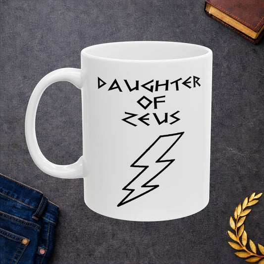 A minimalist black graphic for a white ceramic mug featuring a large, central outline of a lightning bolt. Above the bolt, the text "DAUGHTER OF ZEUS" is written in a sharp, angular font inspired by ancient Greek inscriptions. The entire design is rendered in a clean, high-contrast black outline style.