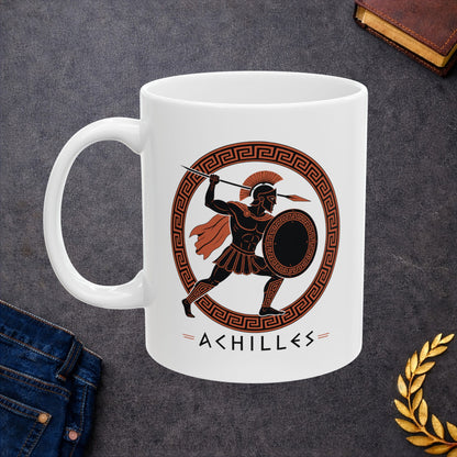 White ceramic mug with a Ancient Greek pottery-style illustration of Achilles, the legendary Trojan War hero, in terracotta orange and black. The warrior wears a crested Corinthian helmet, pleated skirt, and flowing cape while raising a spear in dynamic battle pose. He holds a round shield with Greek key pattern. Enclosed in a circular meander pattern border. The name 'ACHILLES' appears below in geometric letters. Celebrates the hero's legendary martial strength.