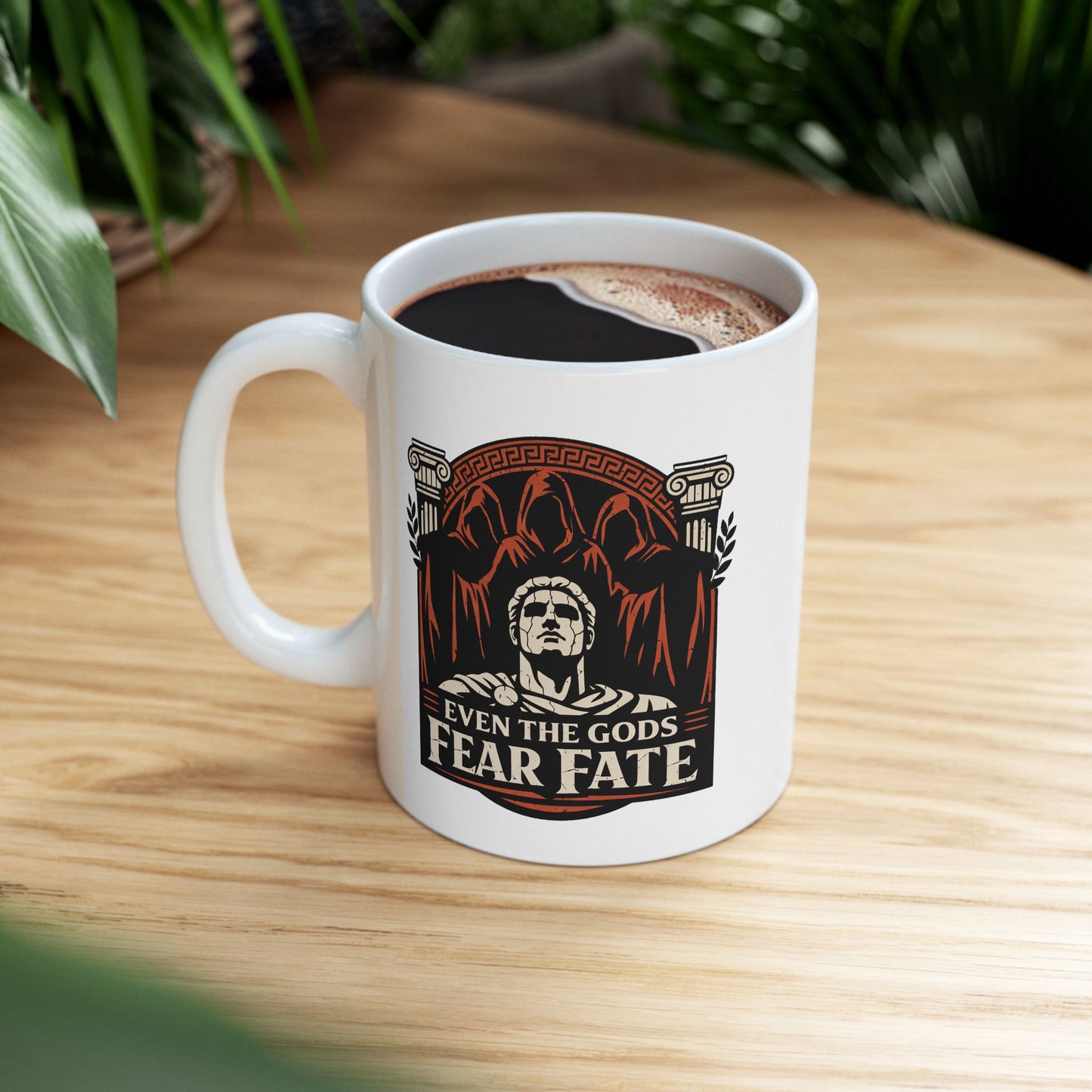 White ceramic mug with a bold, three-tone graphic in black, white, and terracotta. The design features a cracked marble bust of a Greek god positioned in front of three looming, hooded figures representing the Fates. This central imagery is framed by Ionic columns and a Greek key arch. Below, the text reads "EVEN THE GODS FEAR FATE" in a strong, weathered serif font. The aesthetic is inspired by ancient Greek pottery.