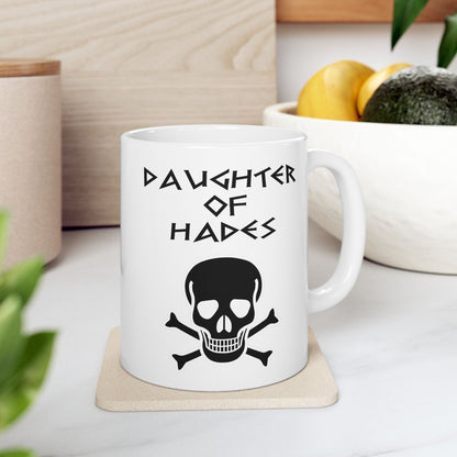A bold, dark-themed graphic for a white ceramic mug. The design features a large, detailed outline of a skull and crossbones at the center. Above the skull, the words "DAUGHTER OF HADES" are written in a sharp, ancient Greek-inspired angular font. The entire design is rendered in a clean, high-contrast black outline style.
