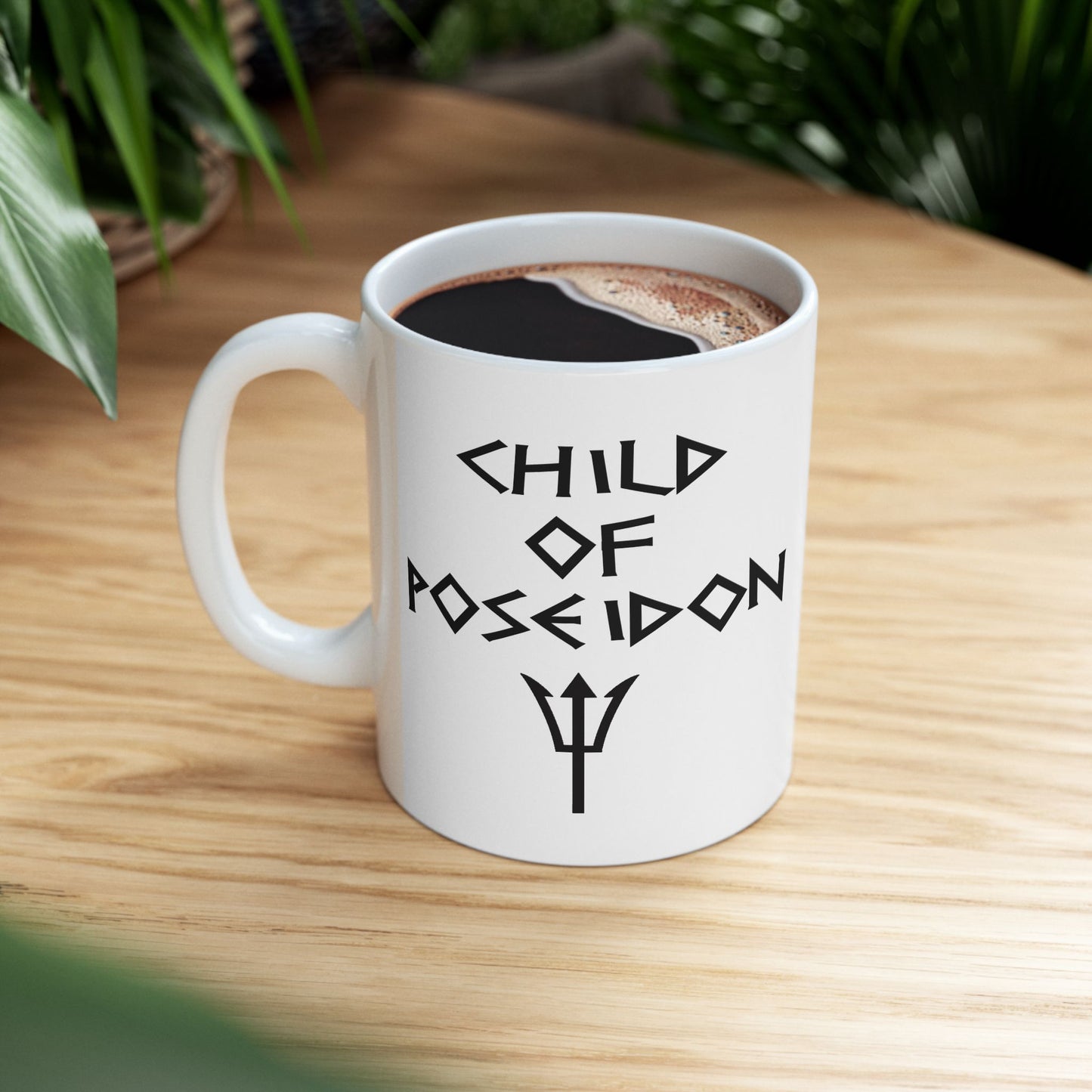 A minimalist black graphic for a white ceramic mug featuring a central silhouette of a trident. Above the trident, the text "SON OF POSEIDON" is written in a sharp, angular font reminiscent of ancient Greek epigraphy. The entire design is rendered in a clean, high-contrast black style.