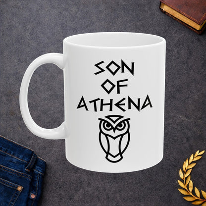 White ceramic mug graphic featuring bold ancient Greek-style lettering reading "Son of Athena" above a clean geometric line-art owl icon — referencing Athena, the Greek Goddess of Wisdom, whose sacred symbol is the owl, rendered in white on black in a striking high-contrast design.