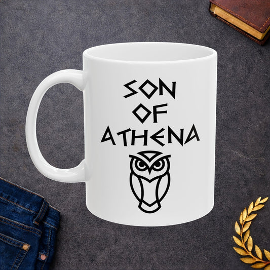White ceramic mug graphic featuring bold ancient Greek-style lettering reading "Son of Athena" above a clean geometric line-art owl icon — referencing Athena, the Greek Goddess of Wisdom, whose sacred symbol is the owl, rendered in white on black in a striking high-contrast design.