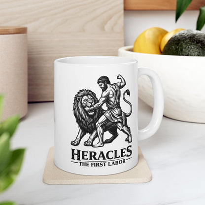 White ceramic mug with a striking black-and-white linocut illustration depicting the Greek hero Heracles wrestling the Nemean Lion. The muscular hero forces his arm into the lion’s open jaws while raising his fist to strike. Below the dynamic scene, bold text reads "HERACLES" followed by a sub-caption that reads "THE FIRST LABOR." The design has a classic, high-contrast vintage woodcut engraving style.