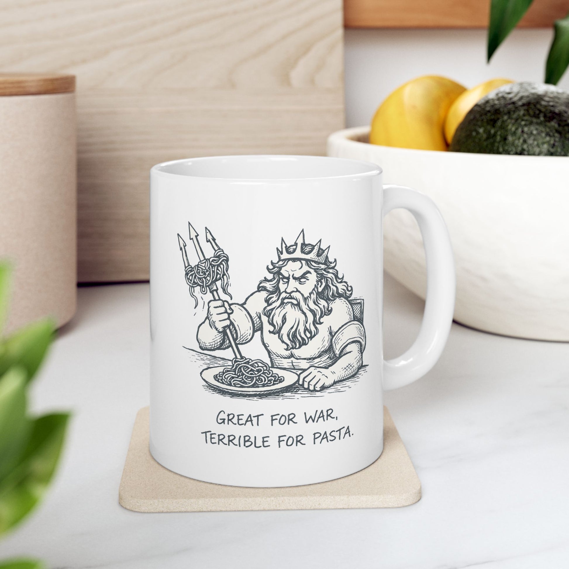 White ceramic mug with a humorous black-and-white sketch of a frustrated Greek god Poseidon attempting to eat spaghetti with his large trident. Strands of pasta are tangled awkwardly around the tines of the weapon. Below the illustration, the caption reads "GREAT FOR WAR, TERRIBLE FOR PASTA" in a distressed, handwritten-style font. The design features a clean, comic-style aesthetic.