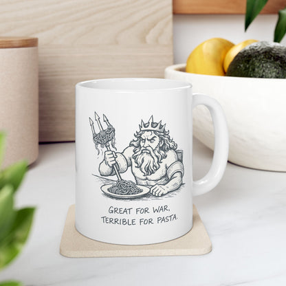 White ceramic mug with a humorous black-and-white sketch of a frustrated Greek god Poseidon attempting to eat spaghetti with his large trident. Strands of pasta are tangled awkwardly around the tines of the weapon. Below the illustration, the caption reads "GREAT FOR WAR, TERRIBLE FOR PASTA" in a distressed, handwritten-style font. The design features a clean, comic-style aesthetic.