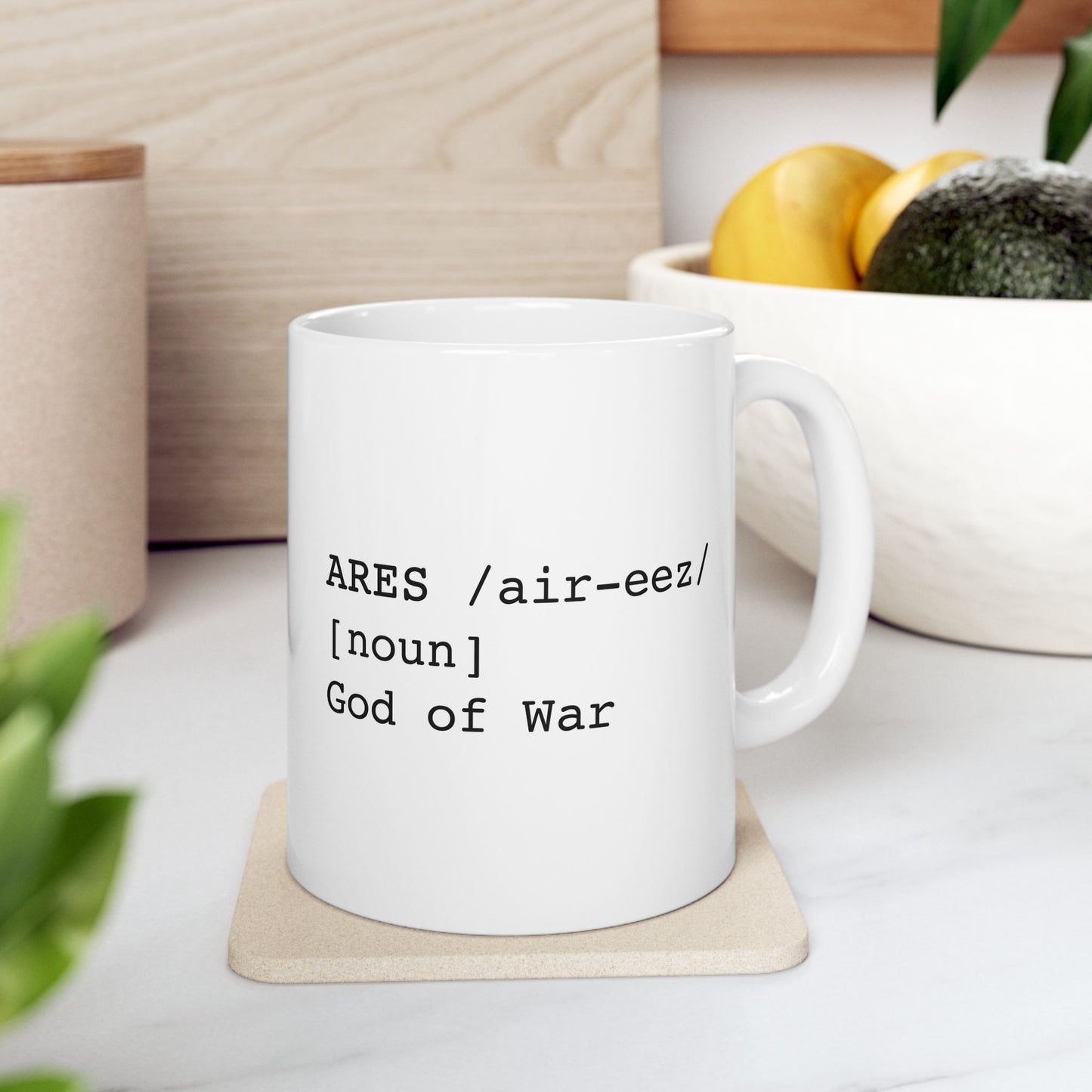 White ceramic mug featuring a dictionary-style definition graphic in black text on a white background. The text reads: 'ARES /air-eez/ [noun] God of War.