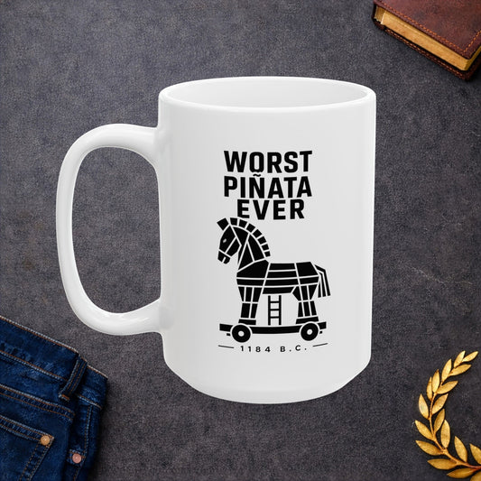 White ceramic mug with a minimalist black-and-white graphic featuring a stylized, geometric silhouette of the Trojan Horse on a wheeled platform with a small ladder underneath. Stacked above the horse, bold black text reads "WORST PIÑATA EVER." Centered below the wheels, a sub-caption reads "— 1184 B.C. —" framed by thin horizontal lines. The clean, high-contrast design offers a humorous, modern take on the ancient Greek myth.