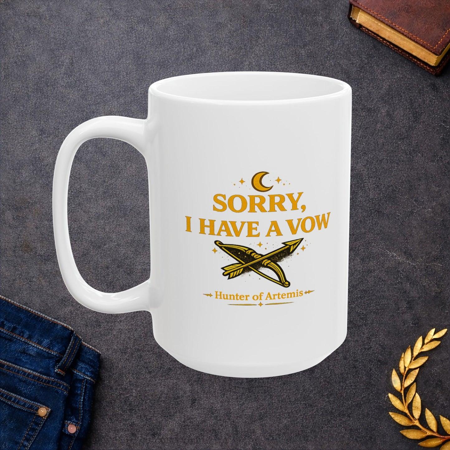 White ceramic mug with a mystical, gold-toned graphic against a dark background featuring the text "SORRY, I HAVE A VOW" in a bold serif font. A golden crescent moon and stars float above the words. Below the main text is a detailed illustration of a crossed bow and arrow surrounded by stardust sparkles, followed by the caption "Hunter of Artemis" framed by decorative gold accents.