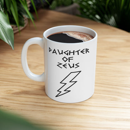 A minimalist black graphic for a white ceramic mug featuring a large, central outline of a lightning bolt. Above the bolt, the text "DAUGHTER OF ZEUS" is written in a sharp, angular font inspired by ancient Greek inscriptions. The entire design is rendered in a clean, high-contrast black outline style.
